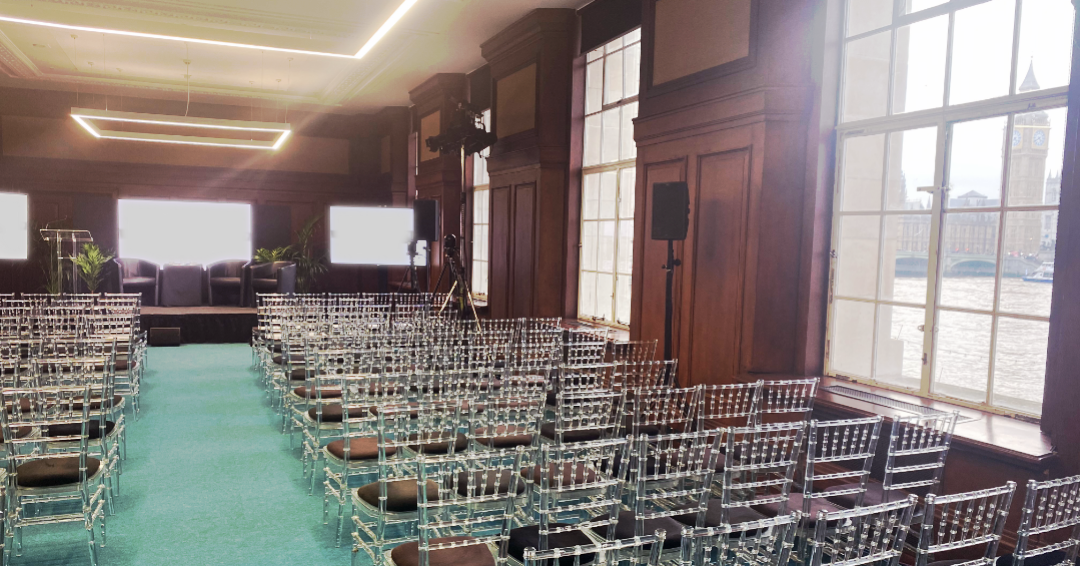 Modern Riverside event space with stage & screens - Banner