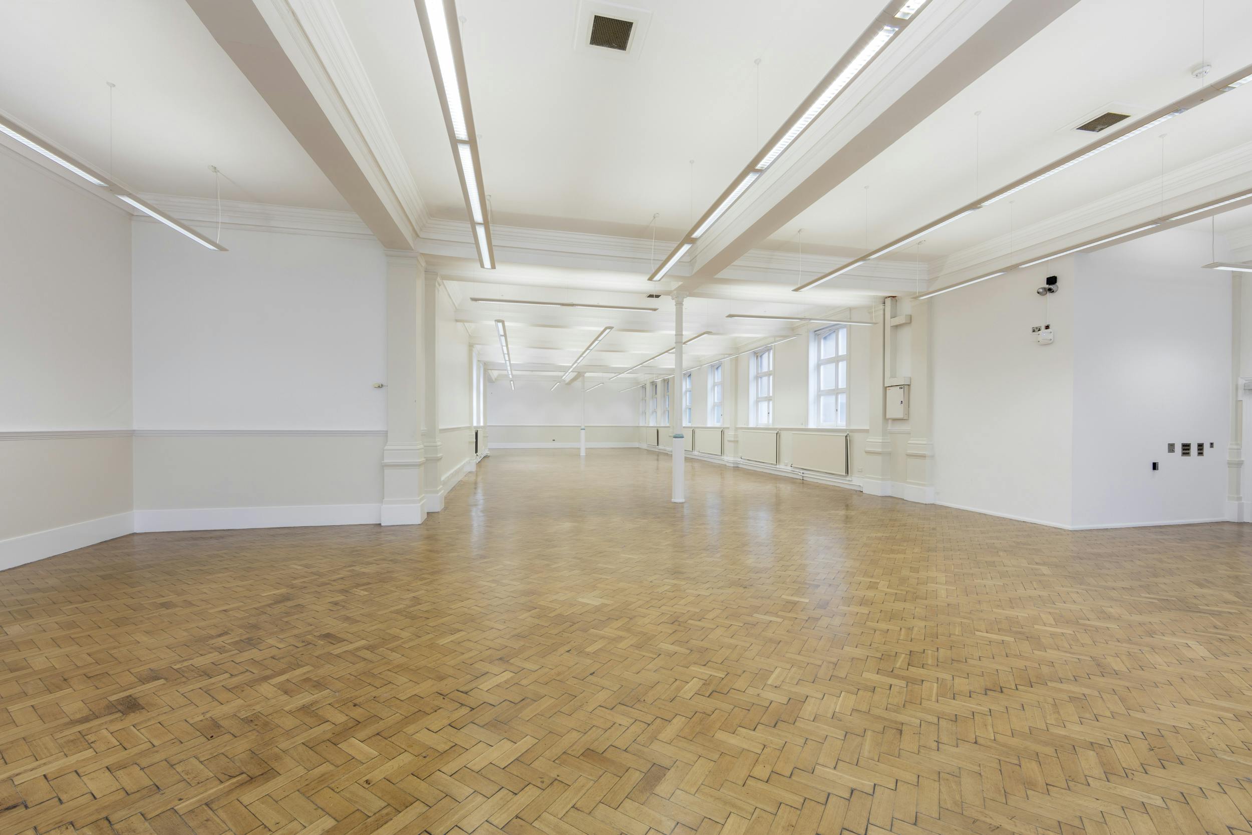 Upper Hall at Bishopsgate Institute, spacious event space with polished wooden floors.