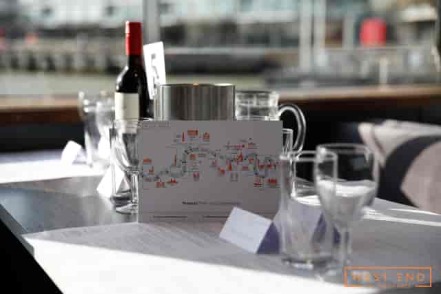 Elegant meeting setup at The Vessel, West End, with upscale glassware and scenic views.