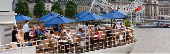 Outdoor dining area at R.S. Hispaniola with blue umbrellas, perfect for summer events.