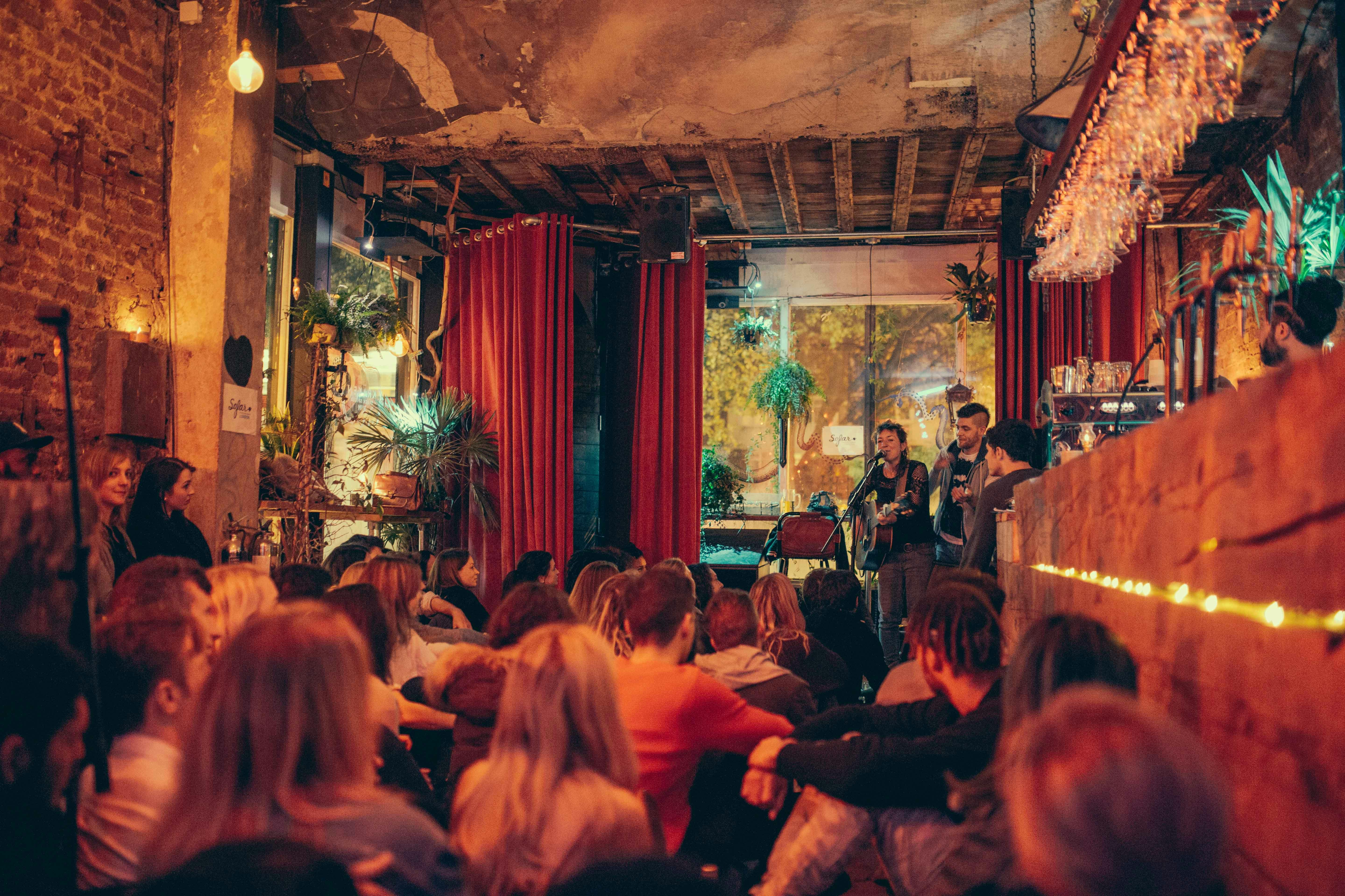 Intimate live music event in cozy venue with warm lighting, perfect for acoustic showcases.