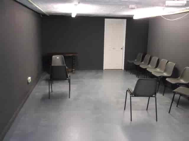 Minimalist meeting space in The Basement, Calder Theatre Bookshop for workshops and discussions.