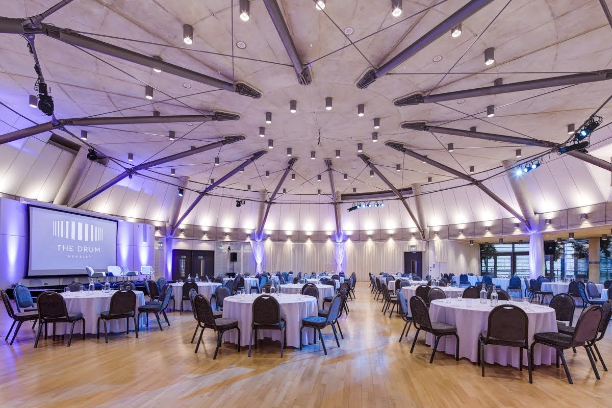 Grand Hall at Wembley: modern event venue with circular tables for conferences and gatherings.