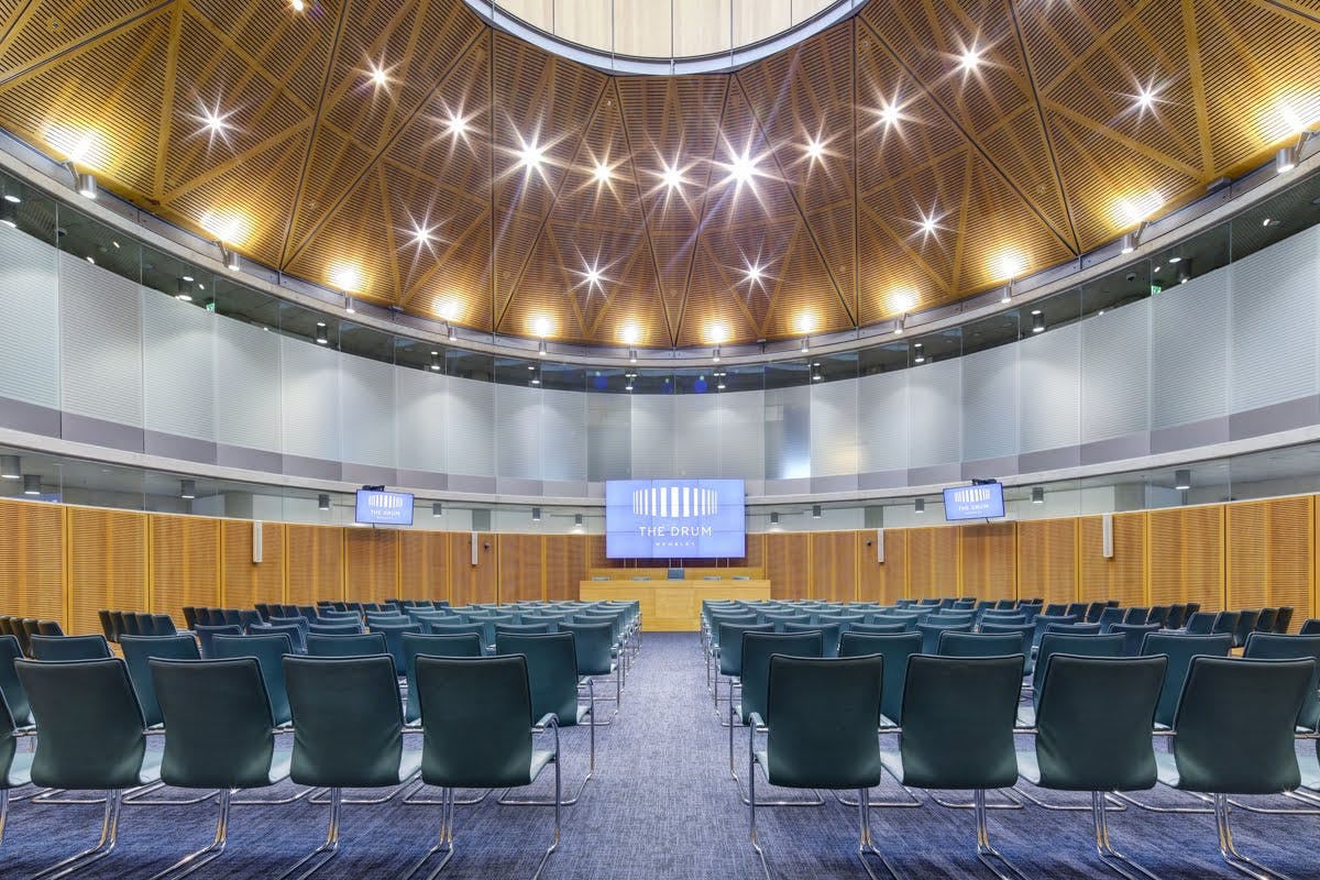 Modern conference hall at Wembley with tiered seating, ideal for corporate events.