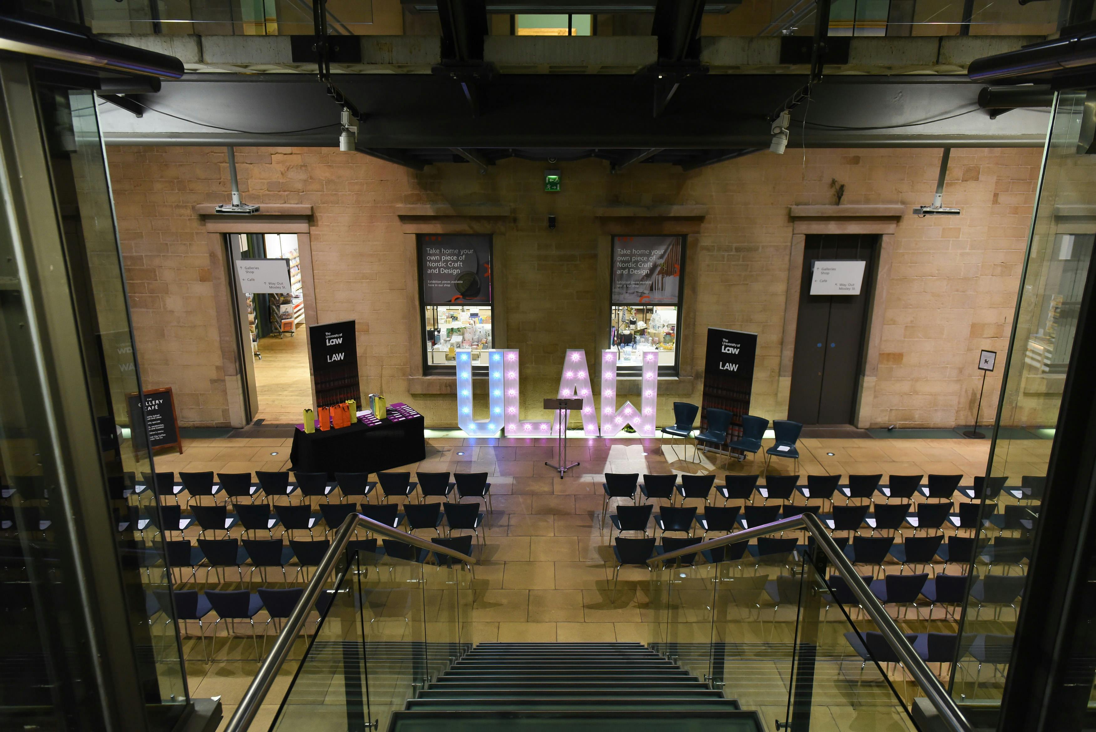 Atrium at Manchester Art Gallery, event space with seating and illuminated theme letters.