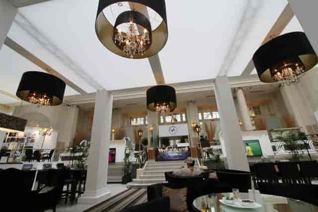 Elegant Palm Court at The Waldorf Hilton, London - upscale event space with chandeliers.