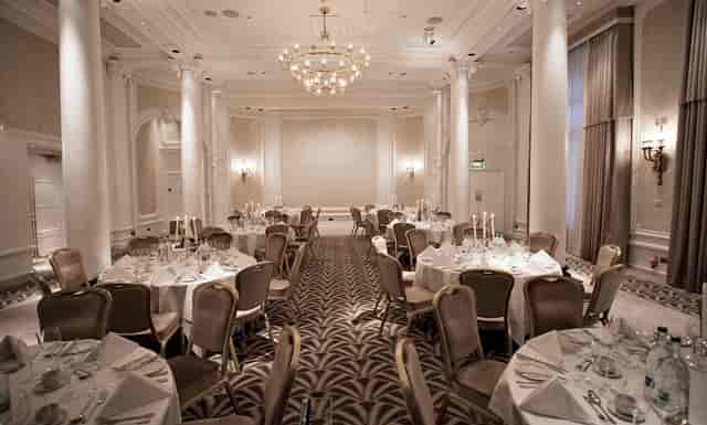 Elegant Adelphi Suite at Waldorf Hilton, London, set for corporate events with candlelit tables.