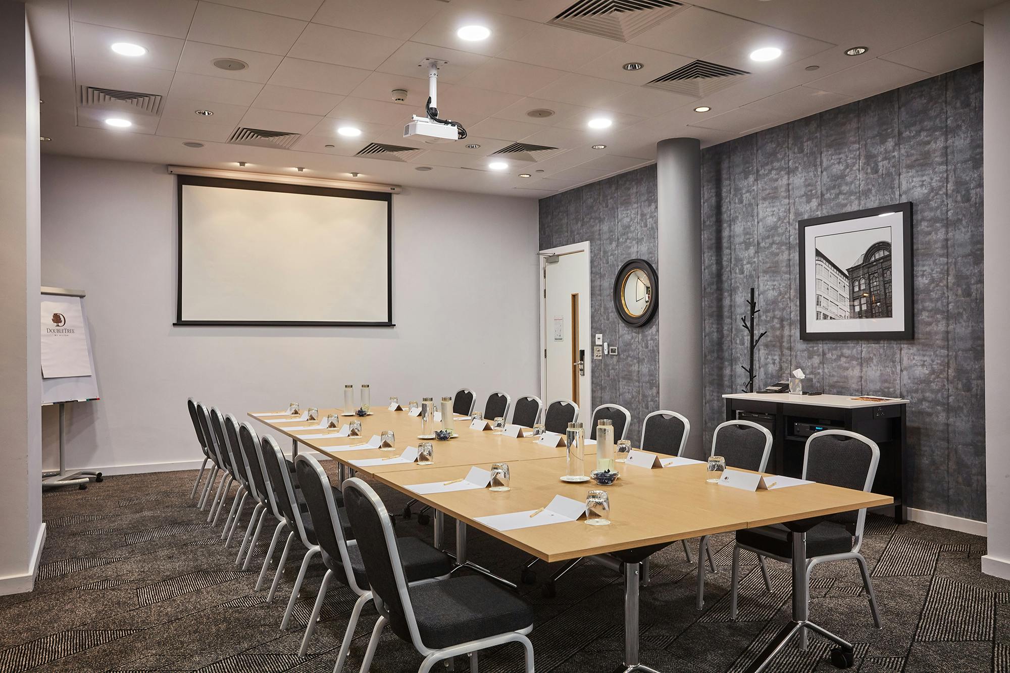 Meeting room at DoubleTree Manchester with projector, ideal for workshops and conferences.