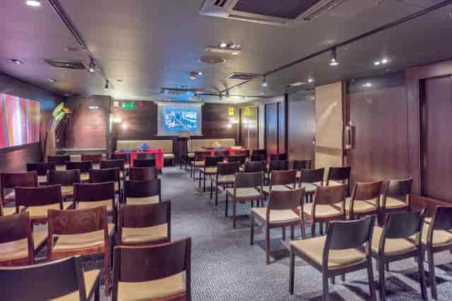Jaipur Room theater-style meeting space with dark wood paneling, ideal for corporate event venue.