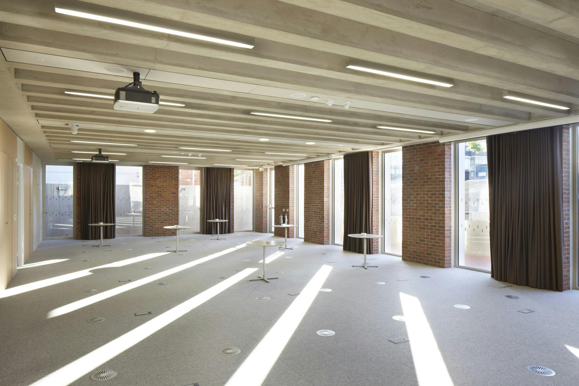 Versatile event space with natural light at ORTUS for meetings and workshops.