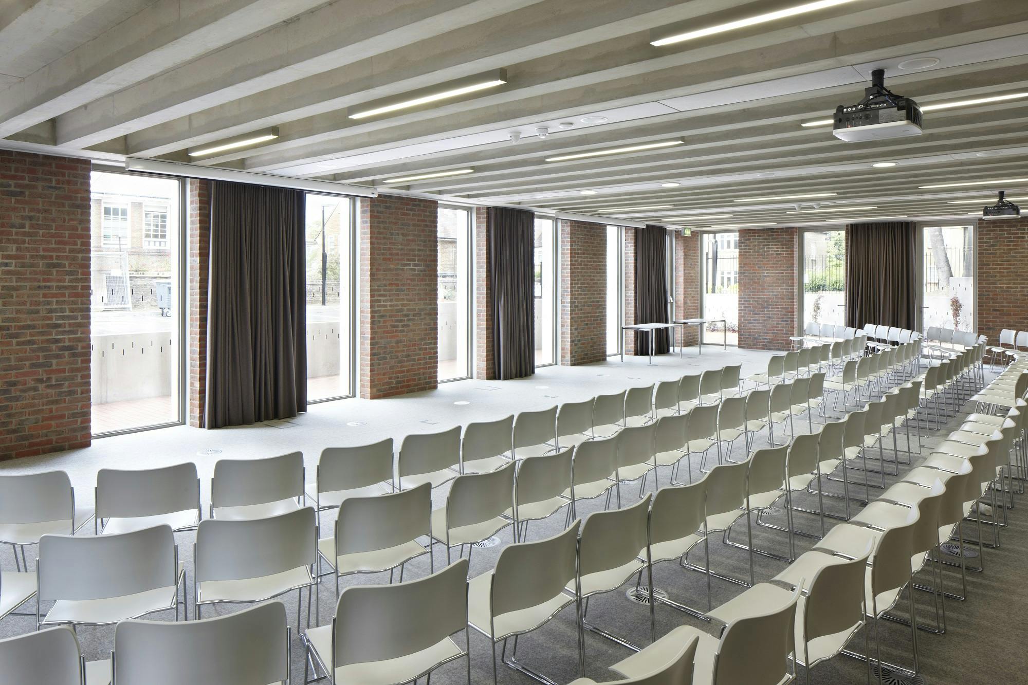 Versatile event space with natural light, ideal for corporate meetings and workshops.