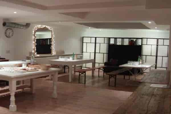Versatile event space in White Hart Wine Room with soft lighting for gatherings.