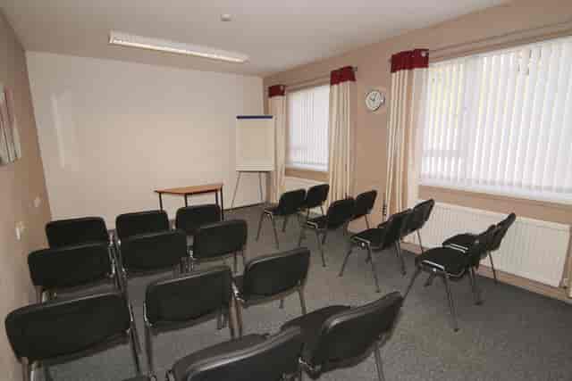 Meeting room in Ayton House with black chairs, ideal for presentations and discussions.