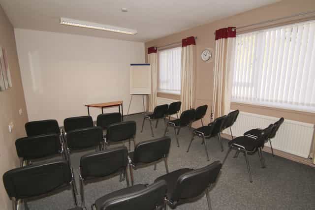 Meeting room in Ayton House with black chairs, ideal for presentations and discussions.
