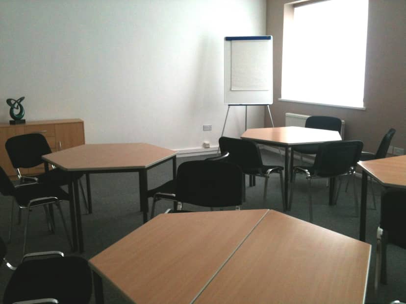 Versatile meeting space in Ayton House with hexagonal tables for workshops and brainstorming.
