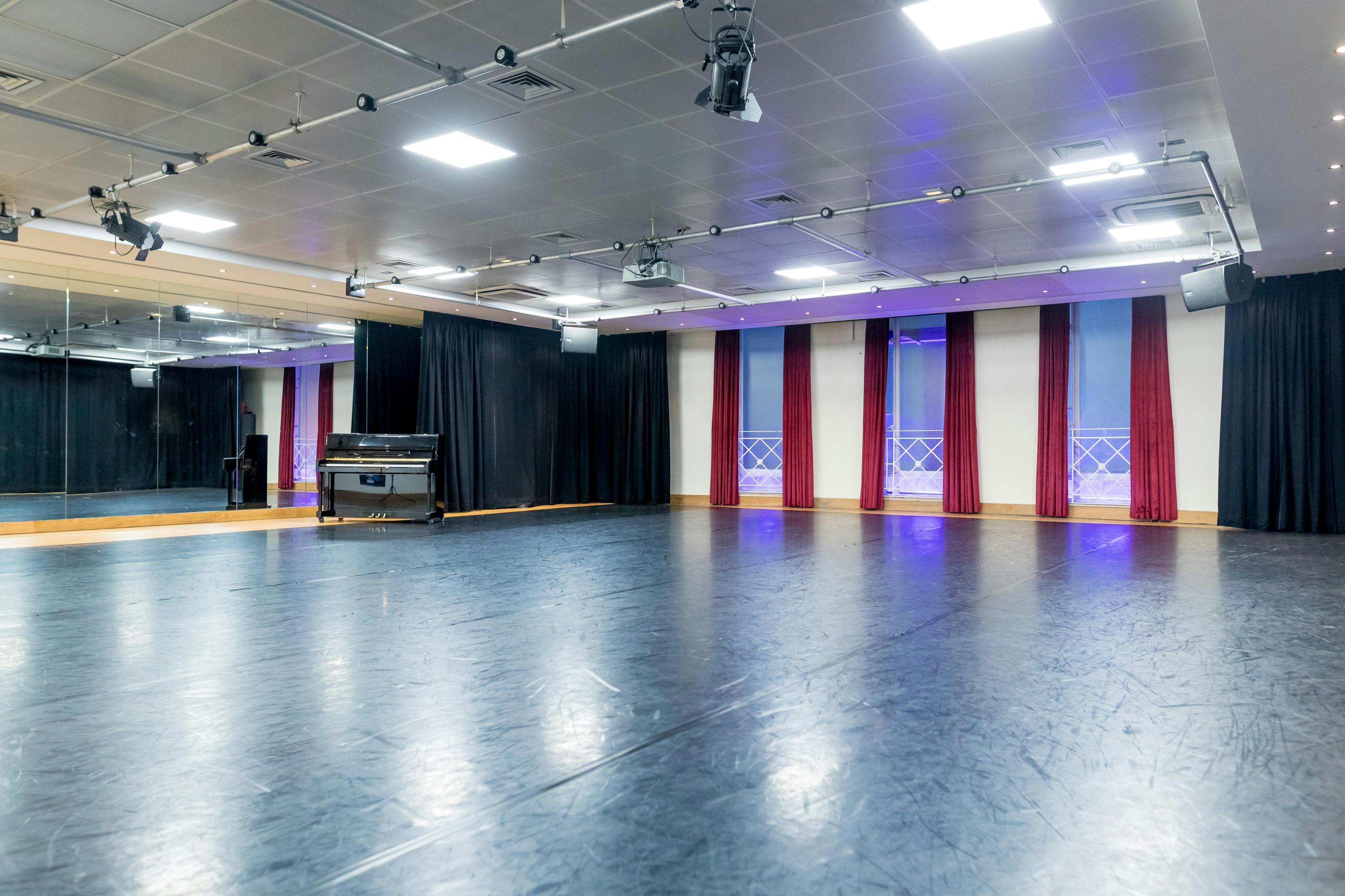 Versatile event space with polished floor and mirrors for dance or fitness classes.