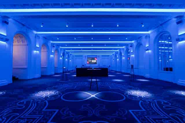 Old Billiard Room venue with blue lighting, ideal for corporate events and upscale gatherings.