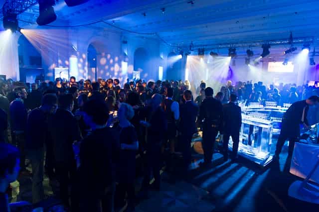 Networking event in Old Billiard Room, vibrant atmosphere with sleek bar setup.