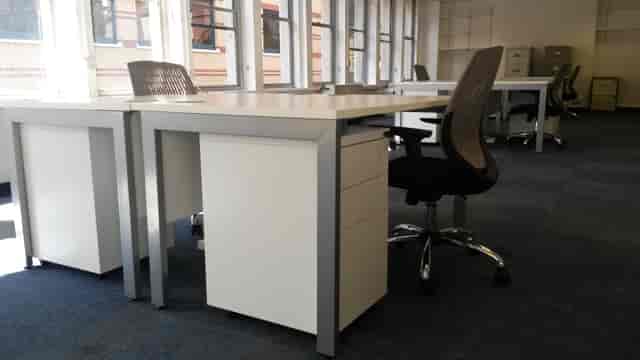 Utilitarian coworking breakout space for small-group collaboration and team meetings.