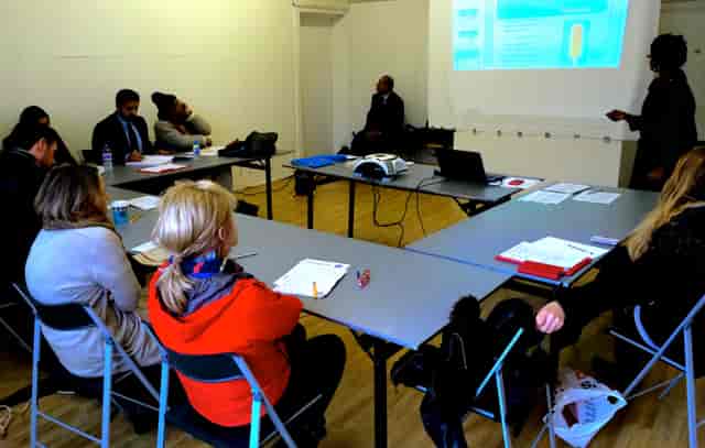 "Meeting at BAR Gallery with engaged participants and projector display for collaboration."