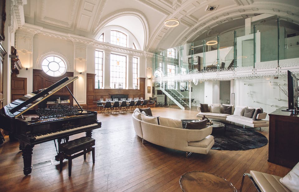 De Montfort Suite at Town Hall Hotel, elegant event space with grand piano, ideal for gatherings.