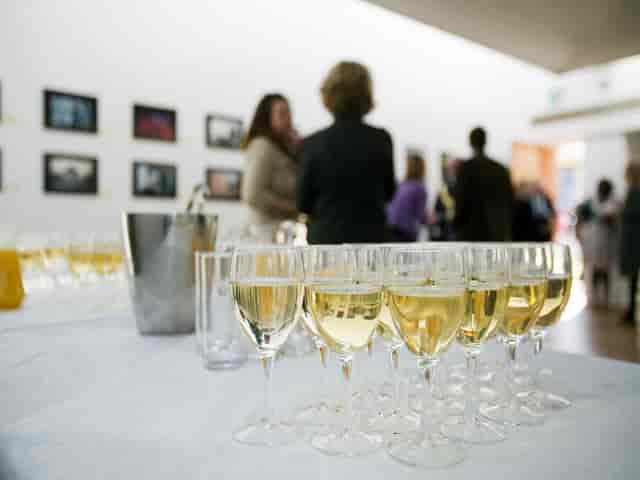 Sophisticated networking event in The Linbury Room with champagne and art ambiance.