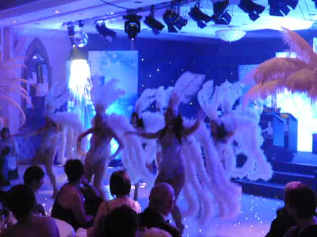 Vibrant Alton Towers Resort stateroom with performers in elaborate costumes for events.