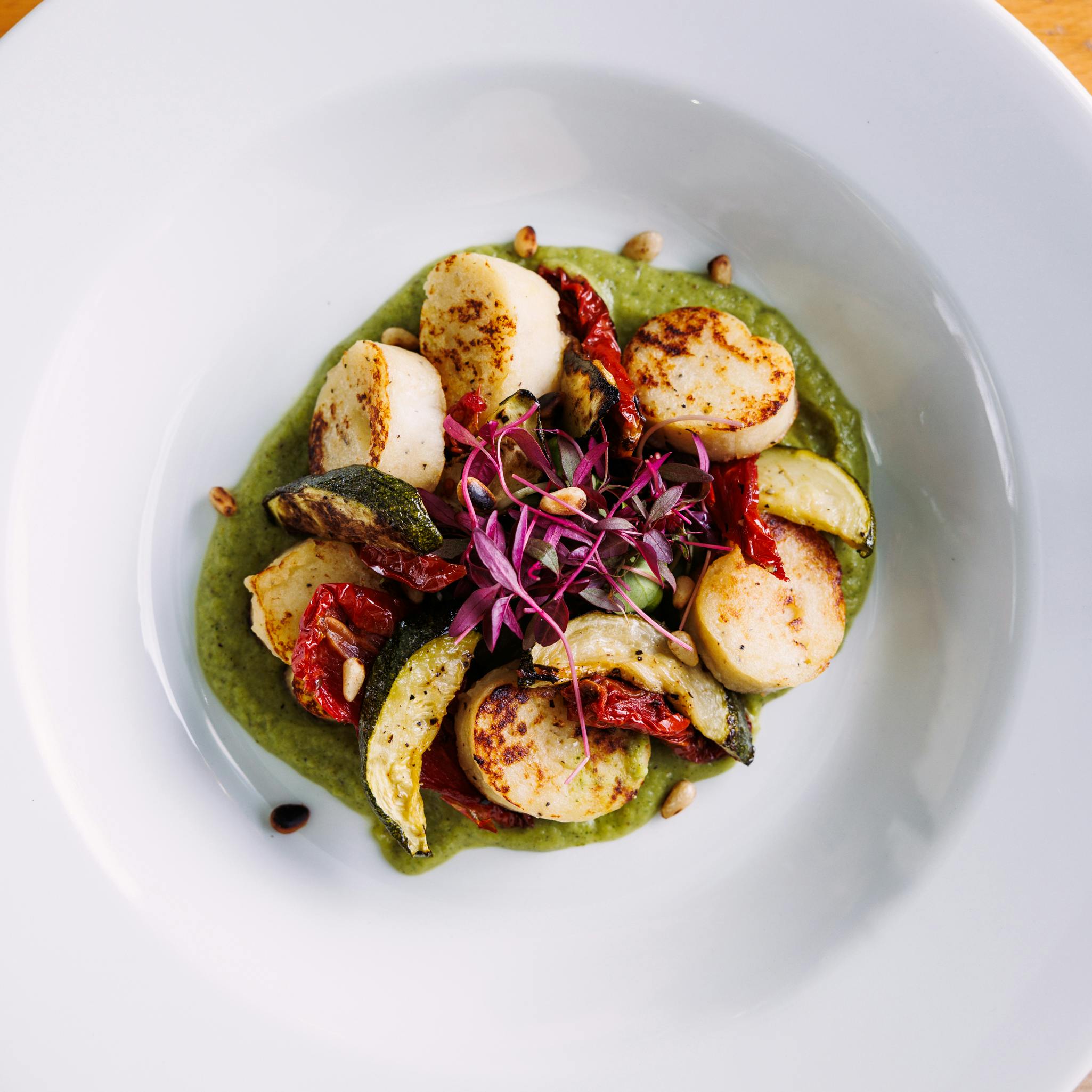 Seared scallops on green sauce at The Jam House, perfect for events and culinary aesthetics.