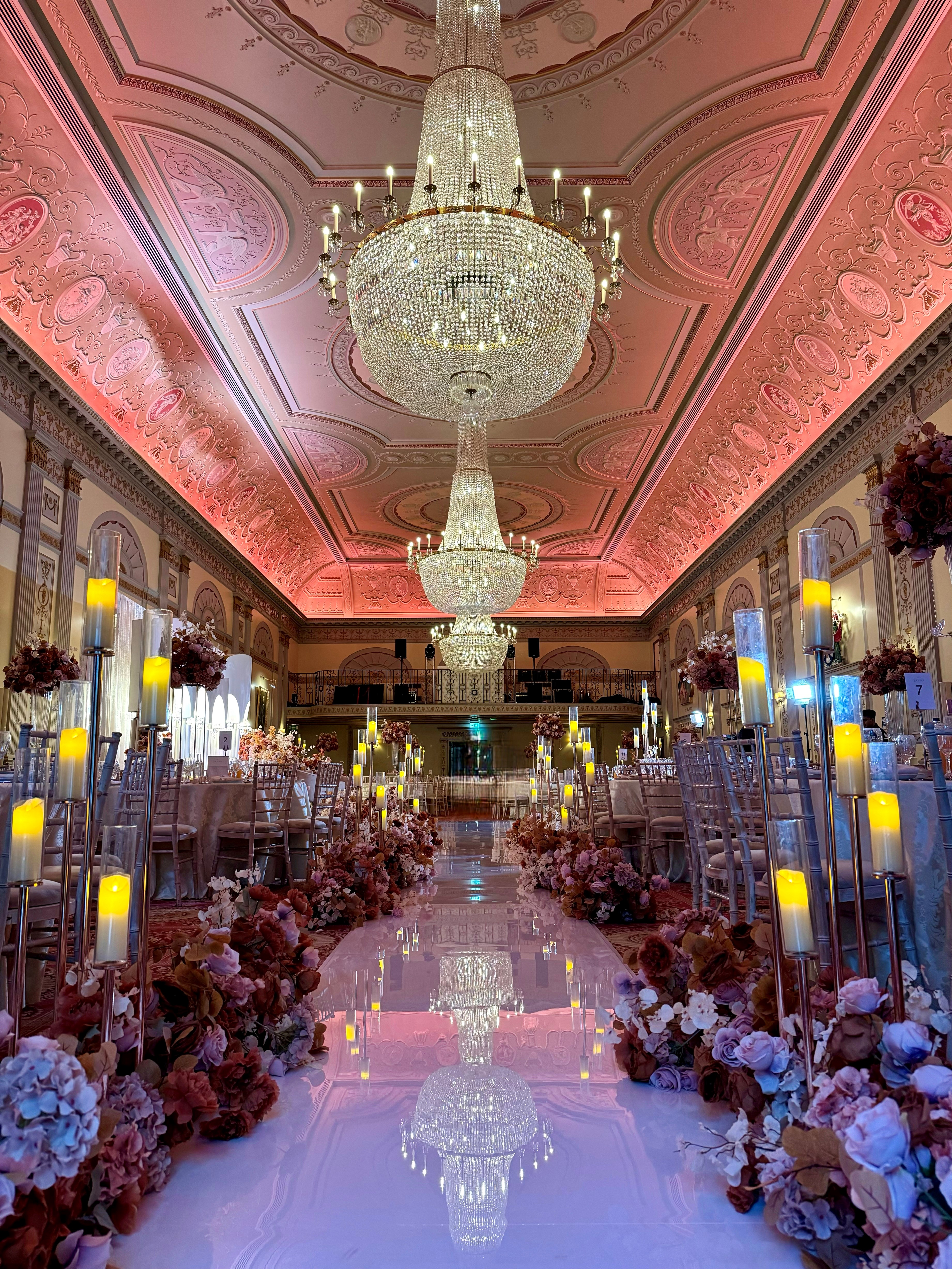 Elegant Plaisterers' Hall event: opulent ballroom, floral decor, luxury. - Banner