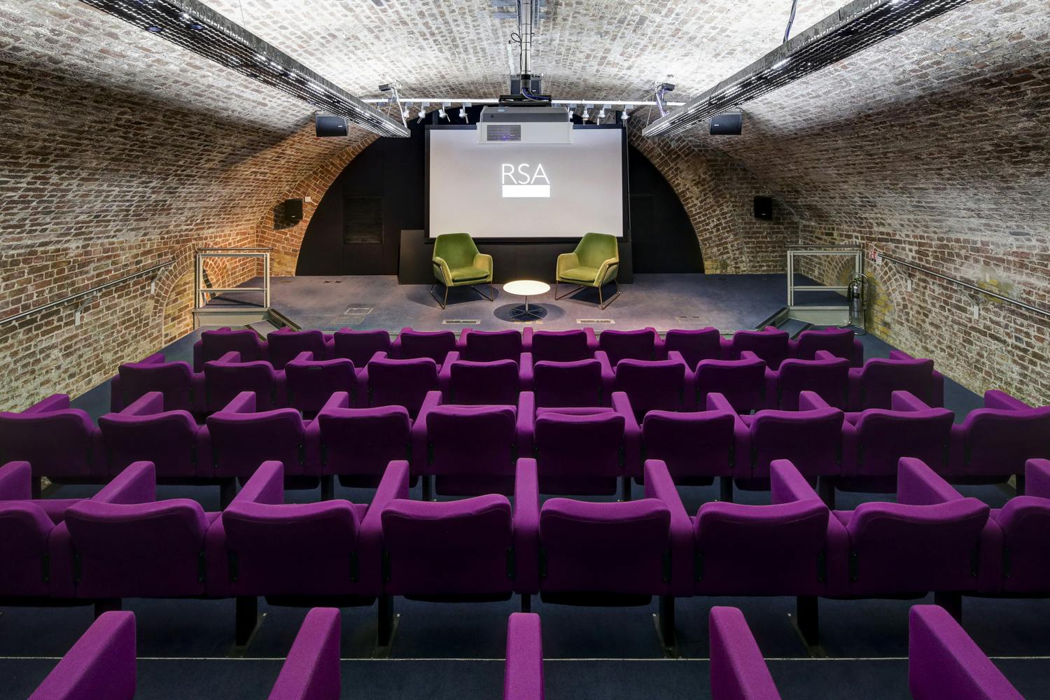 Durham Street Auditorium with purple seating, perfect for conferences and panel discussions.