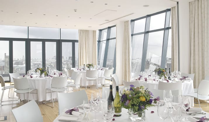 Sophisticated event space with floral centerpieces, ideal for upscale meetings and celebrations.
