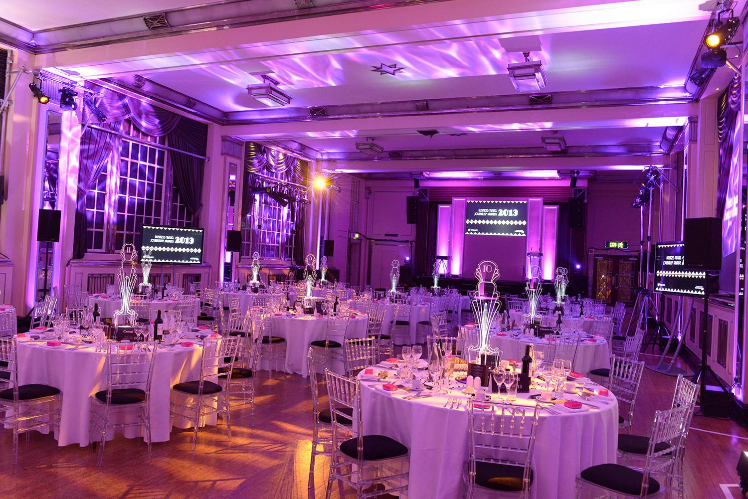Elegant Bloomsbury Ballroom set for a gala with round tables and purple lighting.