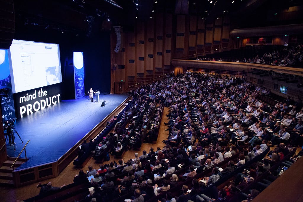 Barbican Hall auditorium with engaged audience at a vibrant conference event.