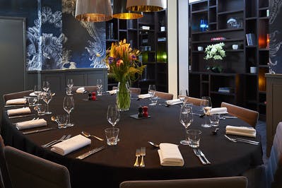 Elegant round table with floral centerpiece in Malmaison London for upscale events.