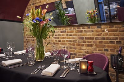 Elegant dining table with floral centerpiece at The Vaults, Malmaison London for corporate events.