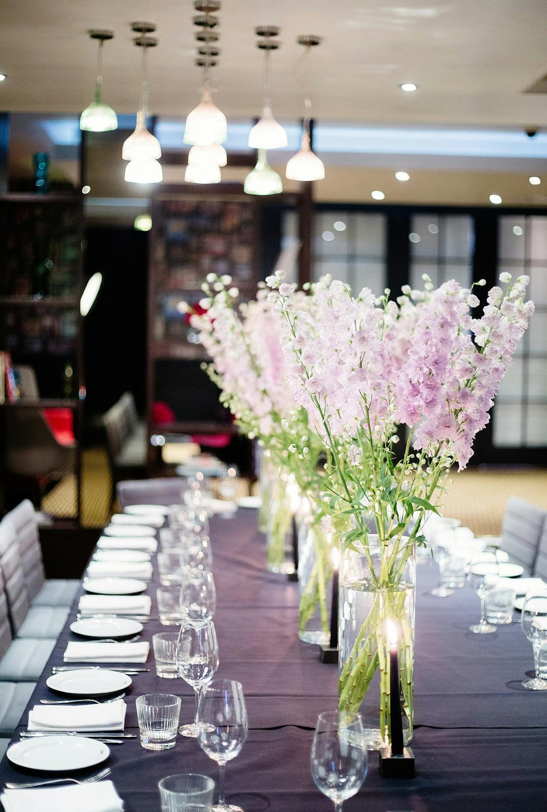 Elegant Mal Lounge event space with pink floral centerpieces for upscale gatherings.