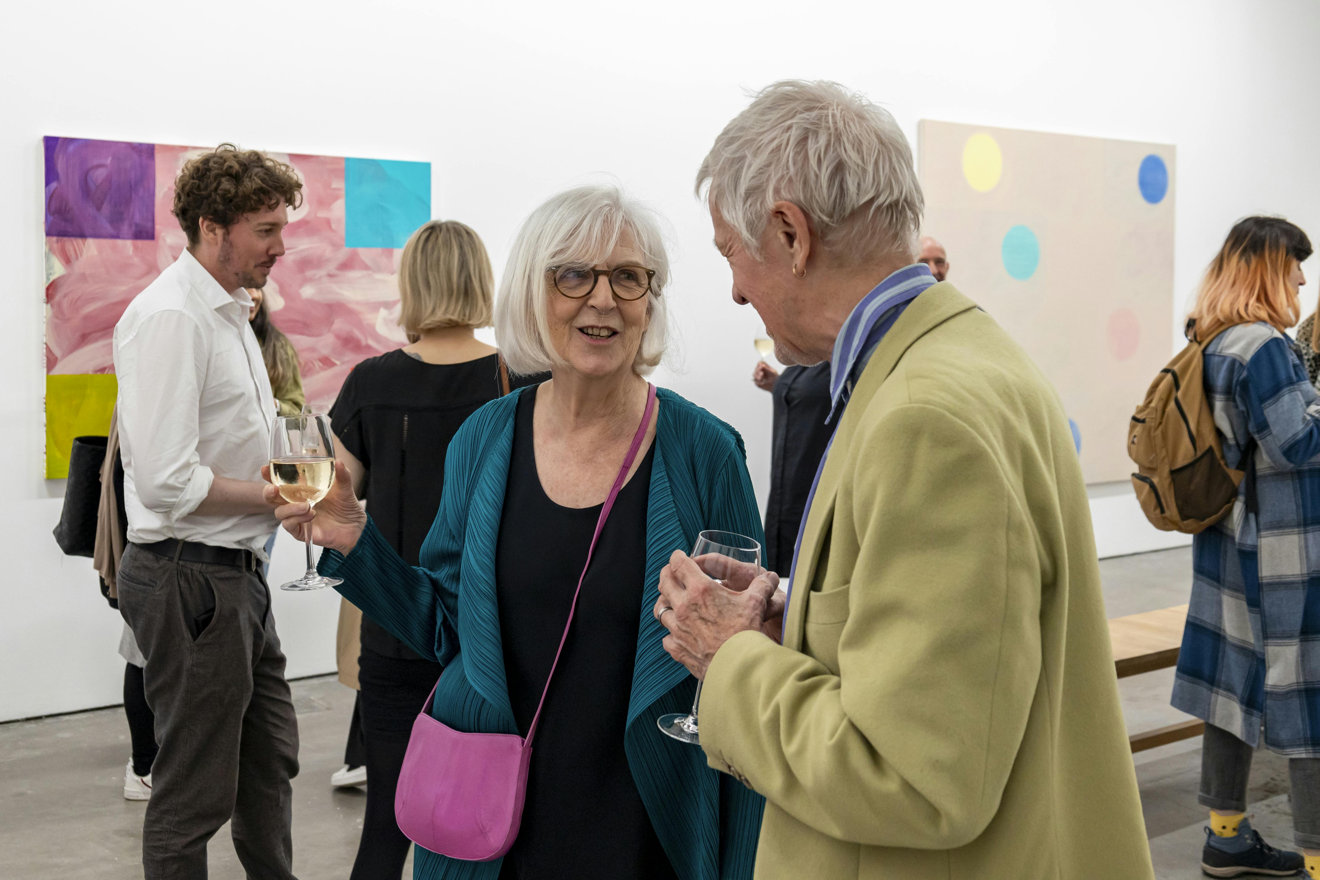 Vibrant networking event at Ikon Gallery with engaging attendees and art backdrop.