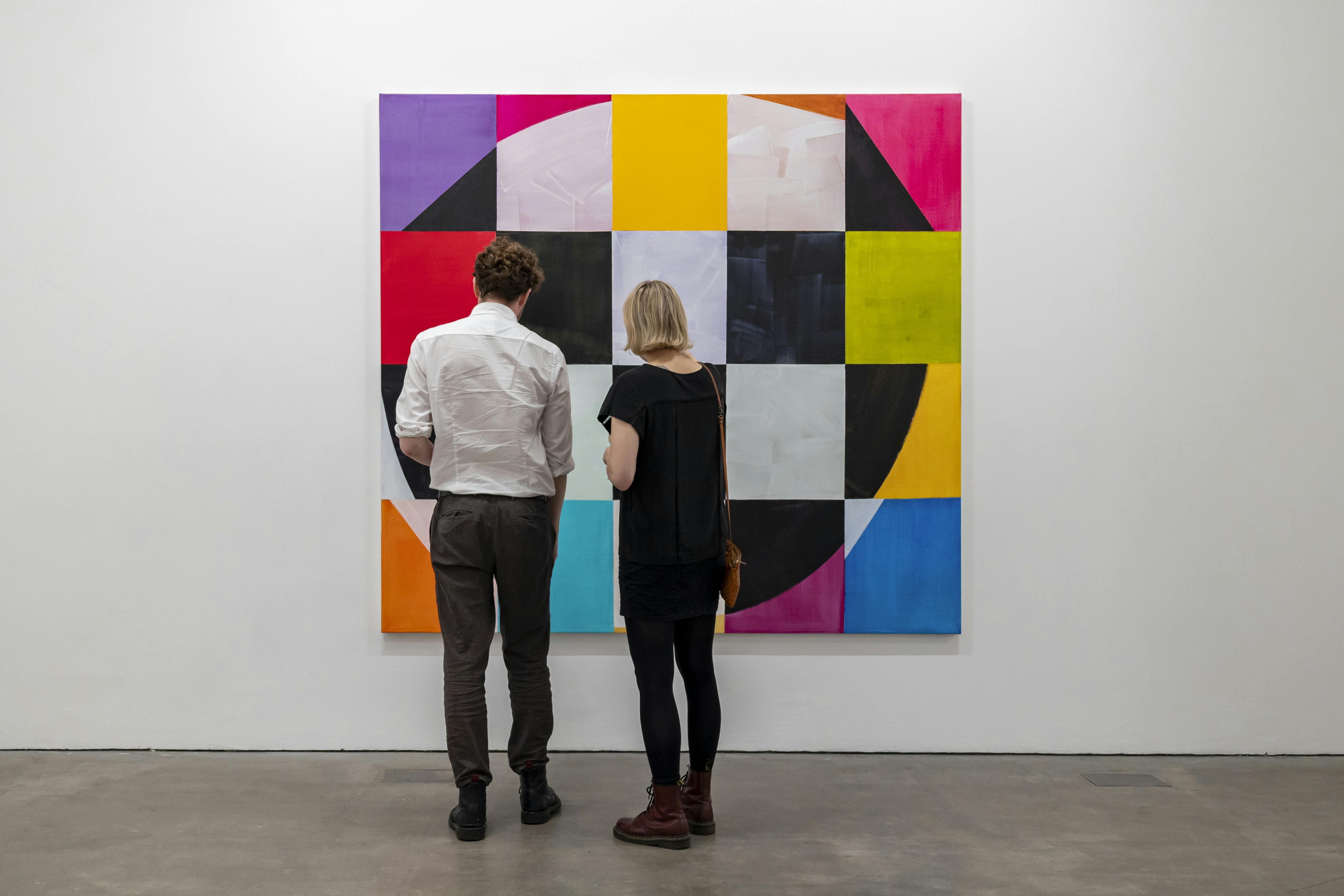 "Two people observing vibrant artwork at Ikon Gallery, enhancing networking and creativity."