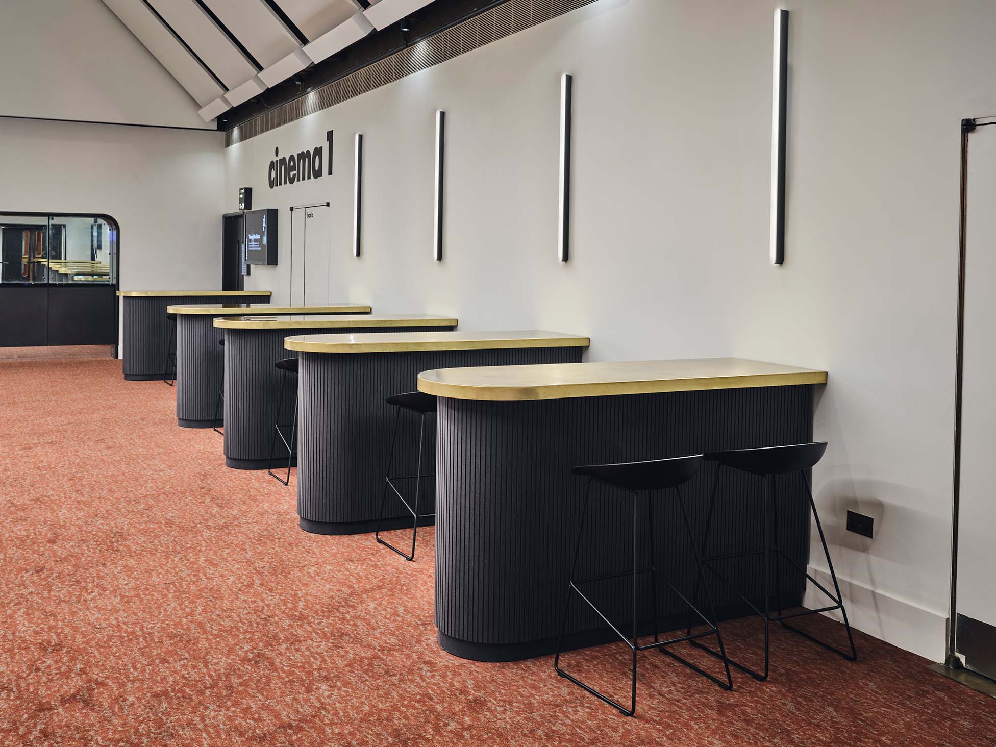 Modern event space in Barbican Centre with stylish reception counters for networking. - Banner