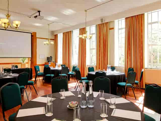 Tuke Common Room: bright meeting space with round tables for workshops and conferences.