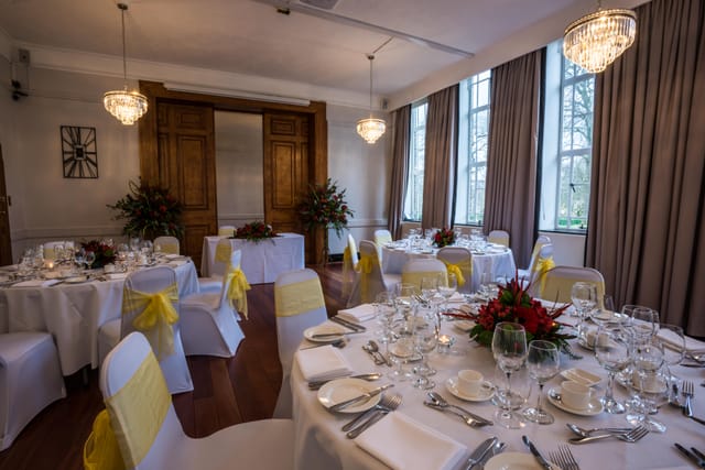 Elegant Tuke Common Room with round tables, ideal for weddings and corporate events.
