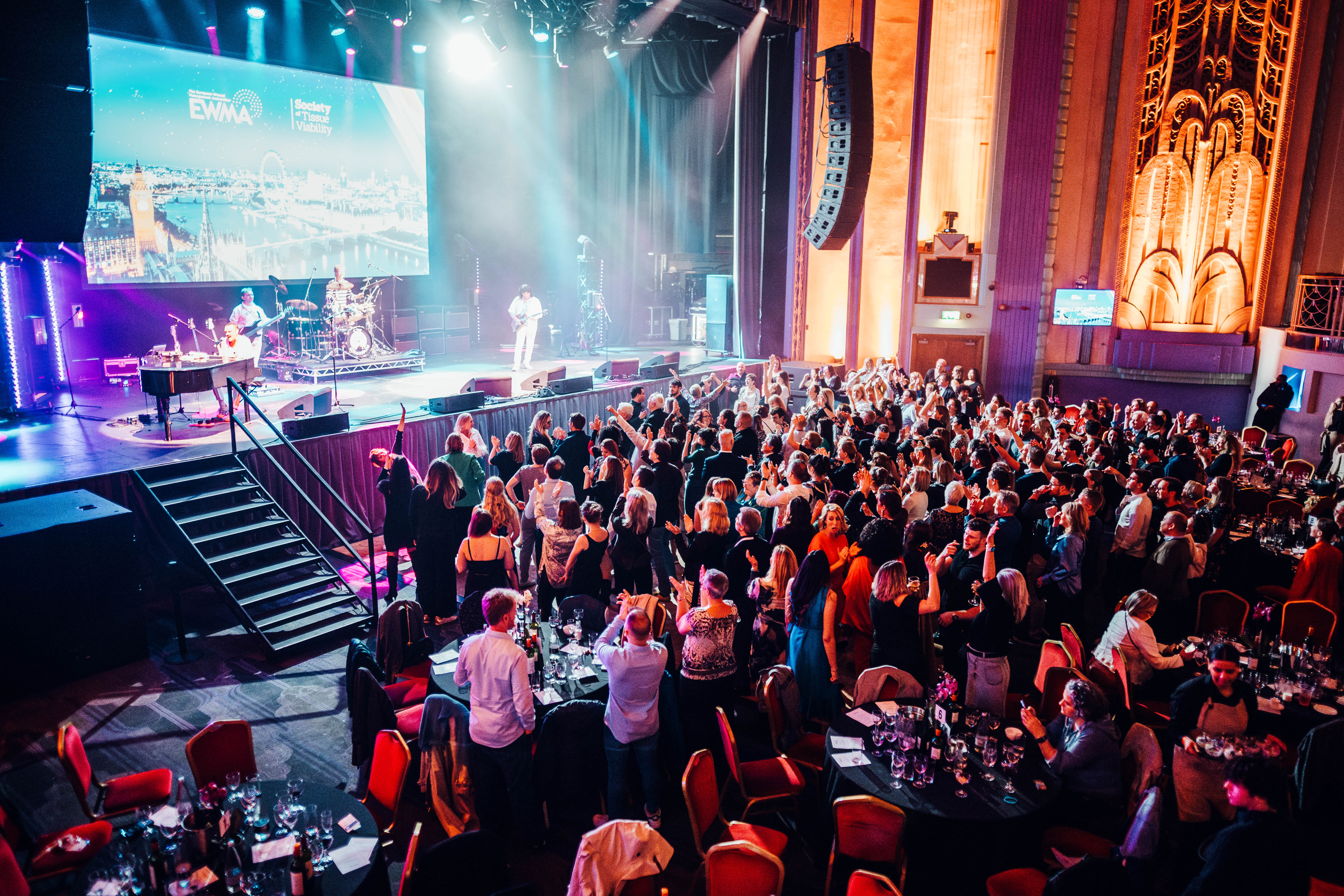 "Christmas party at Troxy with vibrant live performance and elegant dining setup." - Banner