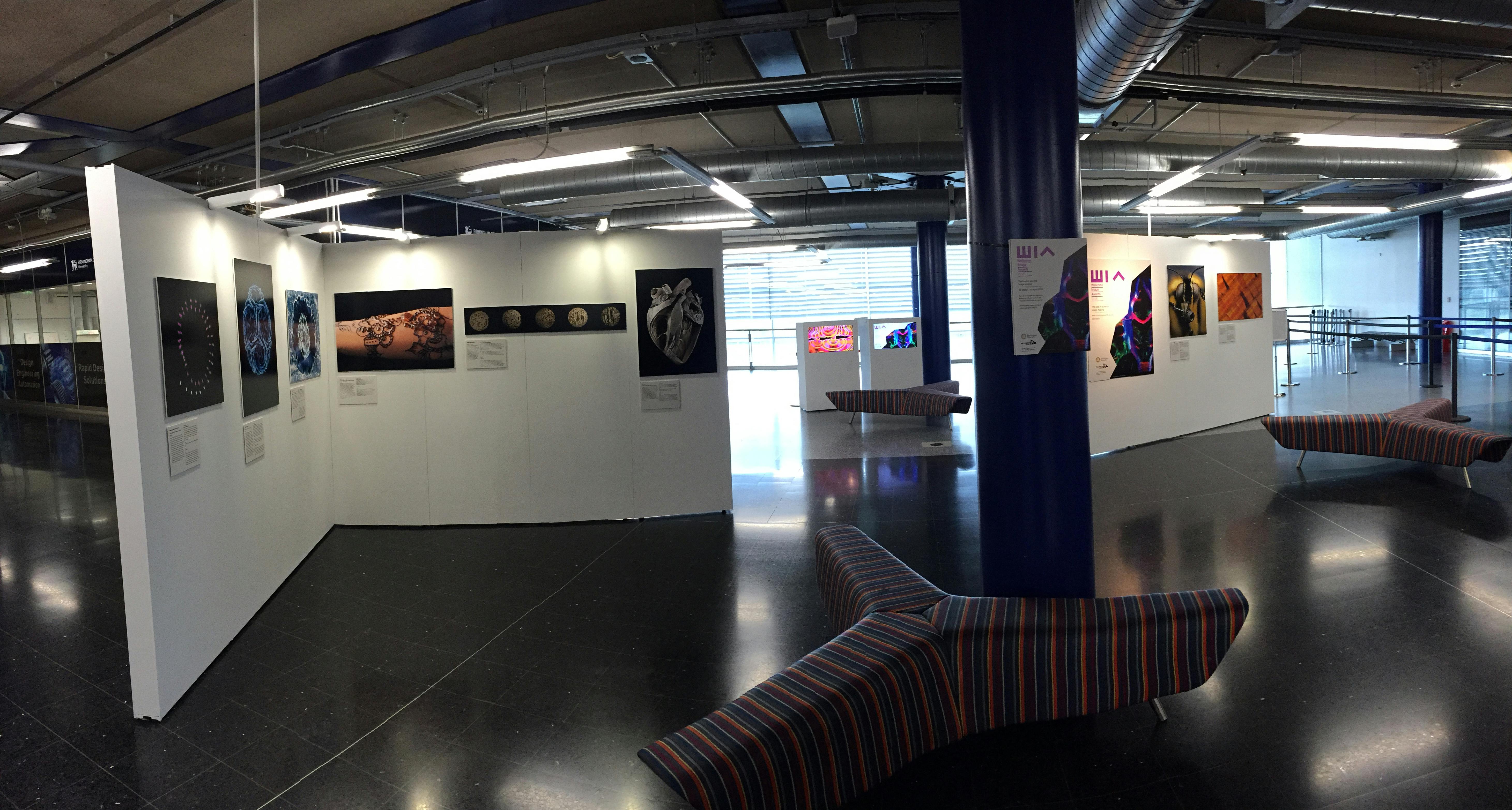 Modern exhibition space at Millennium Point with art displays, ideal for corporate events.