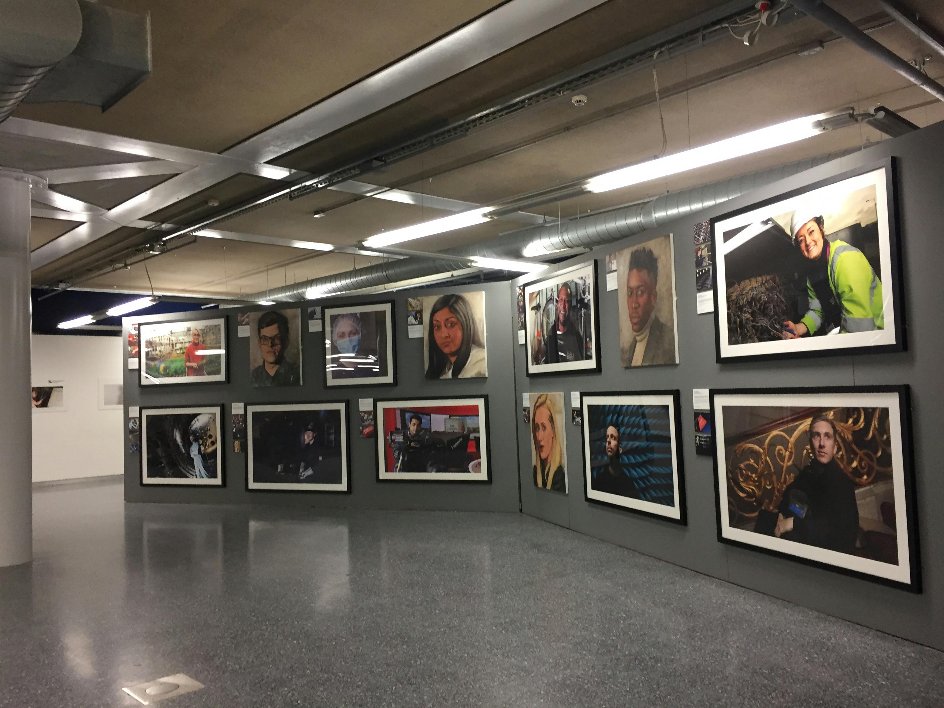 Gallery space with framed portraits at Millennium Point for art exhibitions and networking.