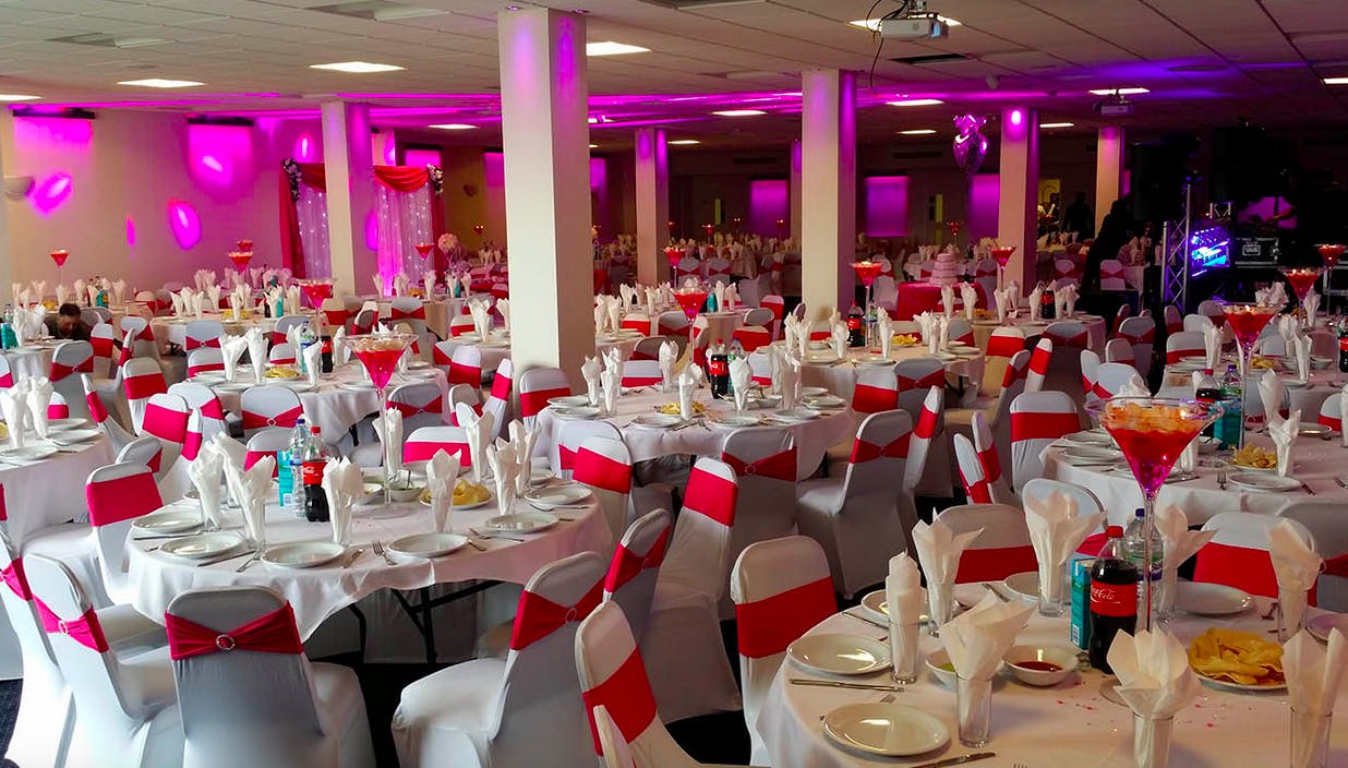 Elegant Saffron Suite event space with round tables, perfect for formal gatherings and celebrations.