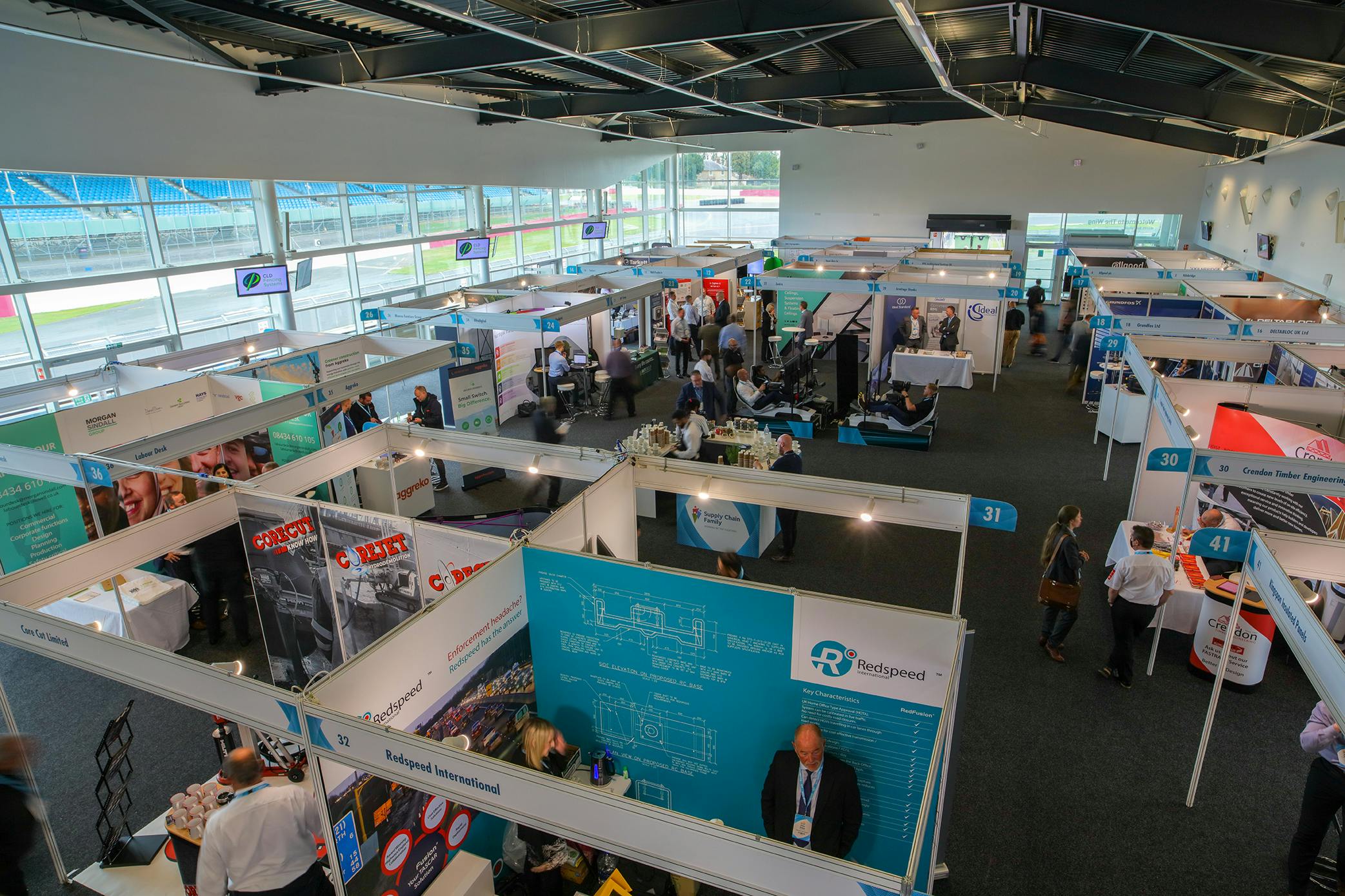 Silverstone conference hall bustling with exhibitors at a trade show event.