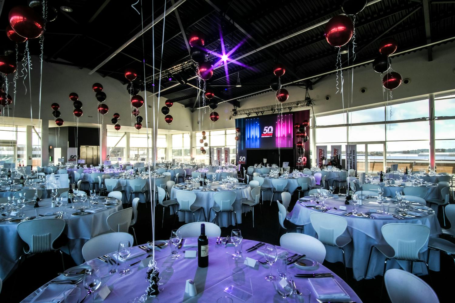 Elegant event space in Silverstone for gala or corporate celebration with round tables.