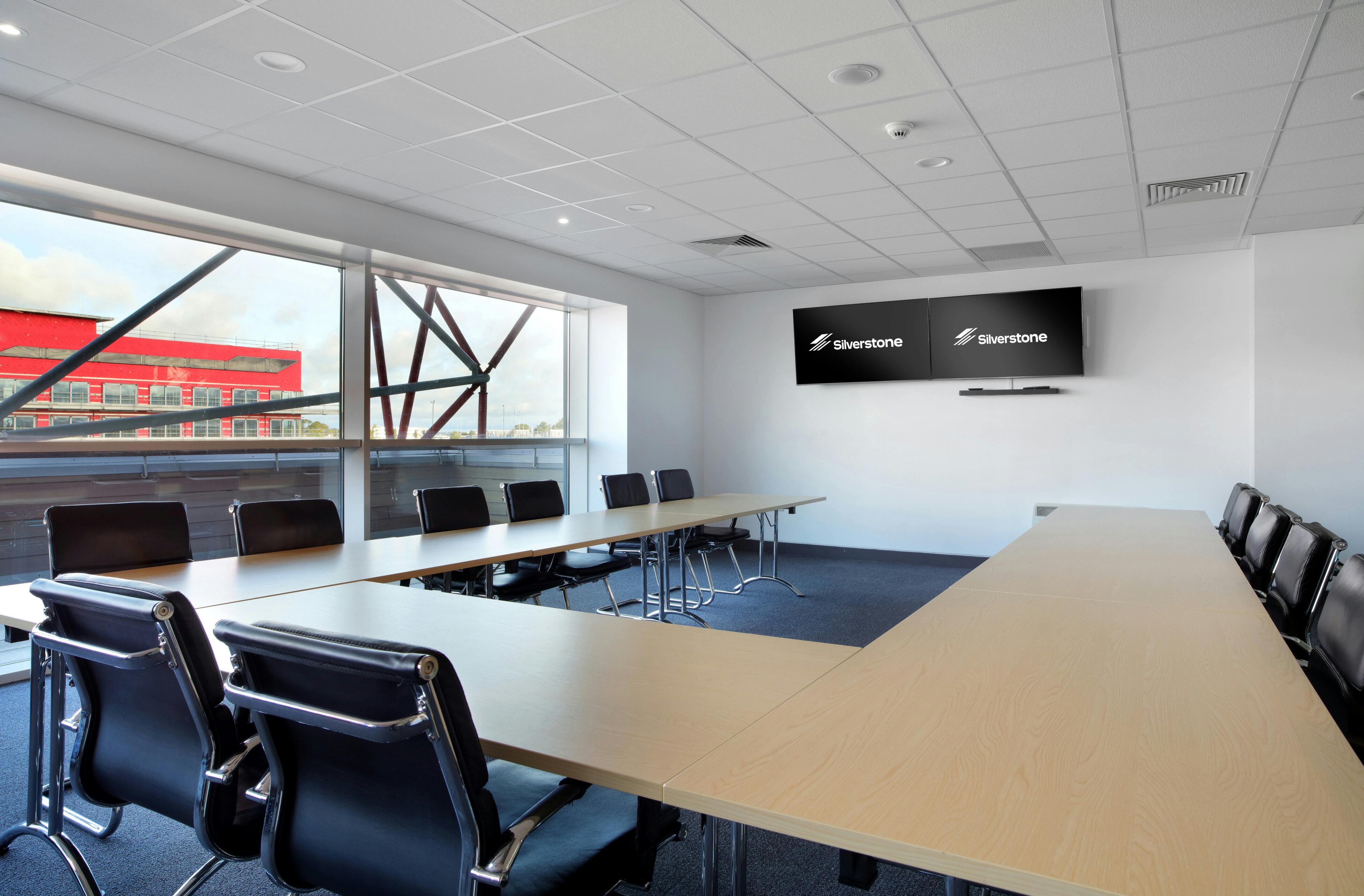 Modern President's Suite at Silverstone for corporate meetings with natural light.