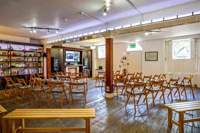 Versatile event space with wooden chairs for meetings and workshops in Anomalous Space.