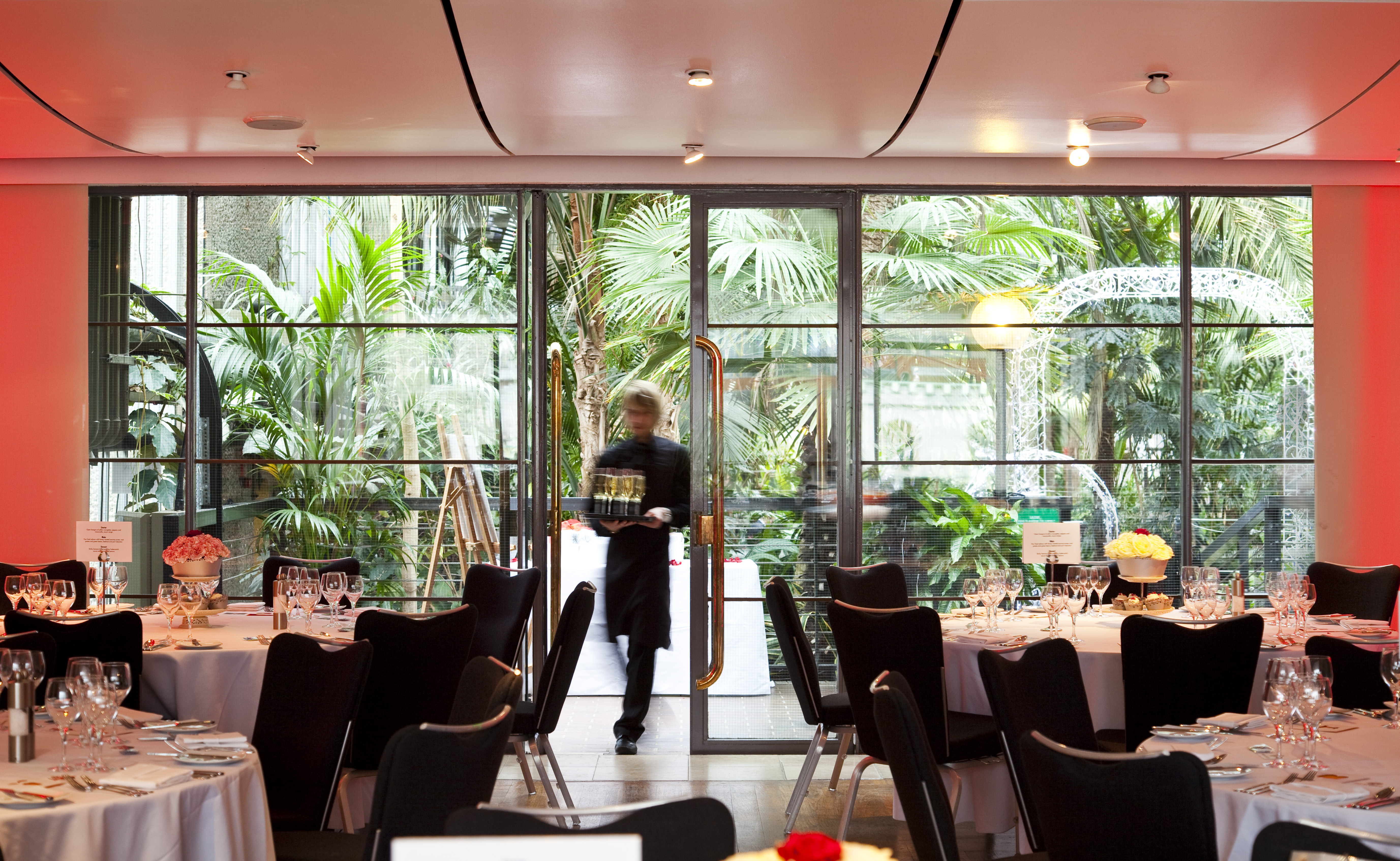 Elegant dining area in Barbican Centre's Garden Room for upscale events and meetings. - Banner